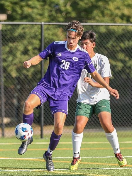 NCS soccer player shielding the ball from a defender